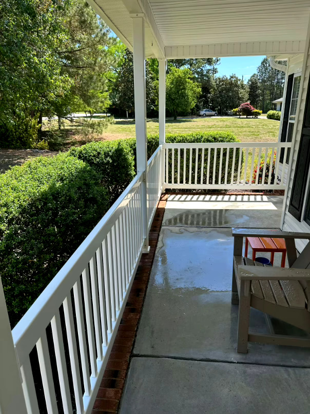 Clean front porch and railing after professional pressure washing